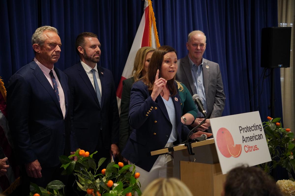 Sen. Ashley Moody (R-Fla.) speaks from the podium at a press conference where Human Services Secretary Robert F. Kennedy Jr. announced a Food and Drug Administration (FDA) rule change for pasteurized orange juice sugar content in Lakeland, Fla., on July 17, 2026. (Jacob Burg/The Epoch Times)