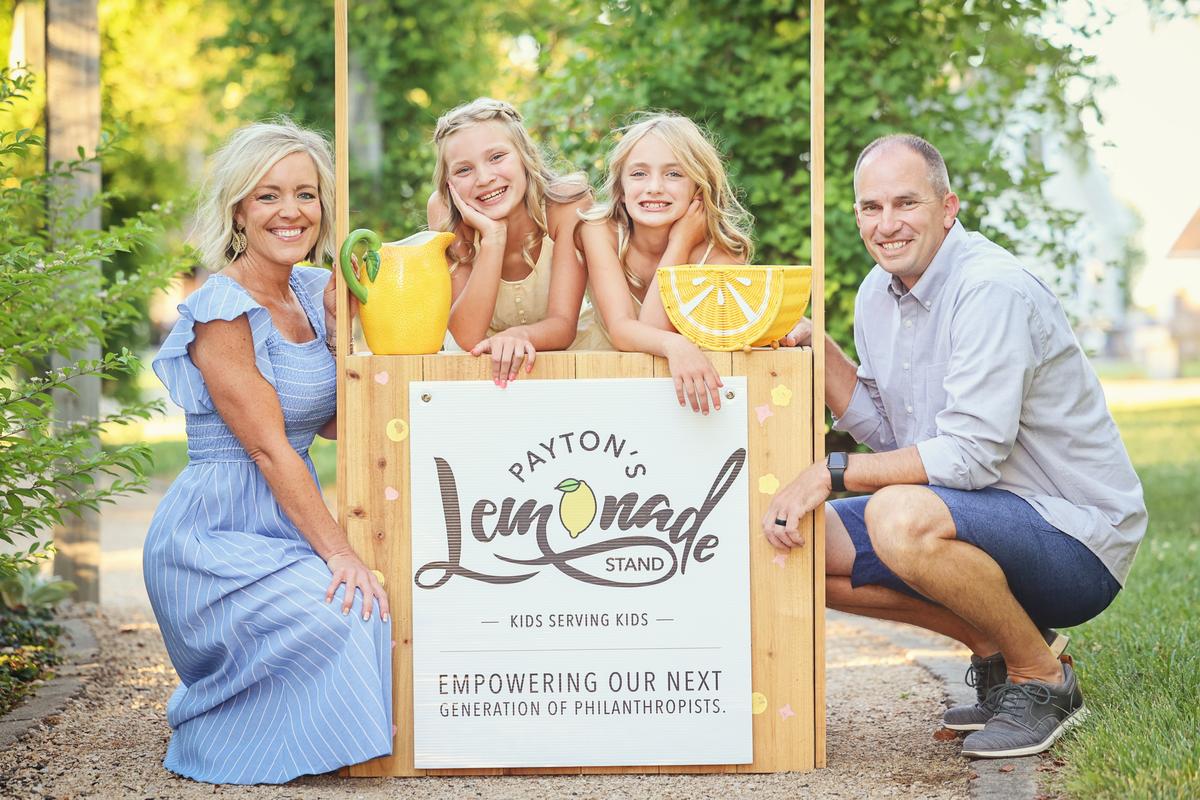 Payton Obert (2L), with her sister Presley and parents Jess and Mike Obert, at her lemonade stand near Cincinnati, Ohio, in 2024. (Courtesy of Jess Obert)