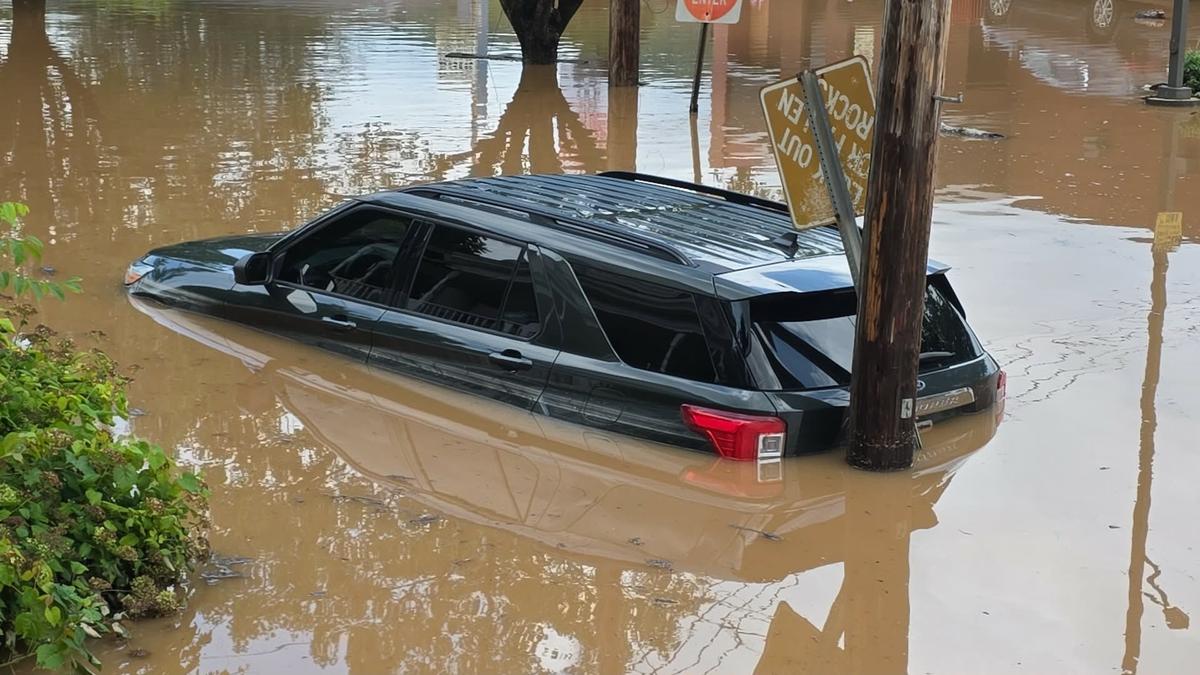 A vehicle sits half-submerged in floodwaters in Buckhannon, W.Va., on July 22, 2026. (Evan Bacorn/via AP).