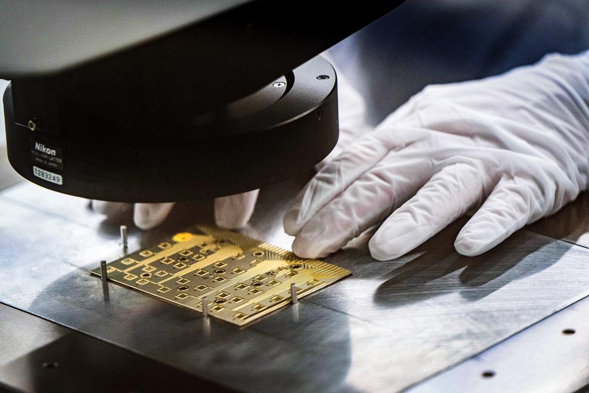 A worker conducts testing in a Coherent manufacturing facility where lasers are developed for transmitting data among chips, which could decrease power use by AI systems, in Sherman, Texas, on June 16, 2026. (Jeffrey McWhorter/AP Photo)