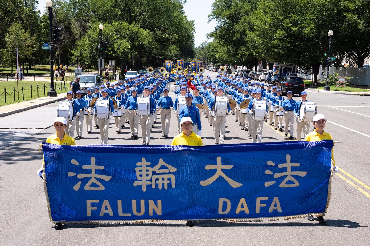 Falun Dafa practitioners take part in a march calling for the end of the Chinese Communist Party’s 27 years of persecution of Falun Gong in China, in Washington on July 23, 2026. (Larry Dye/The Epoch Times)