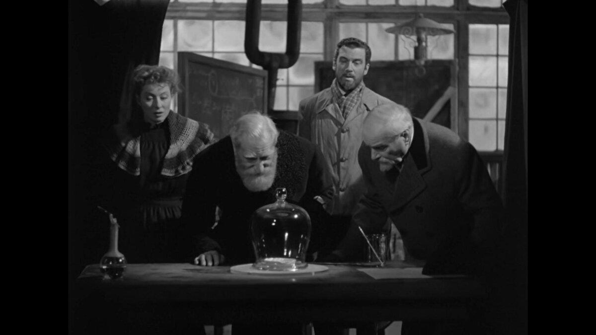 (L–R) Marie Curie (Greer Garson), Jean Perot (Albert Bassermann), Pierre Curie (Walter Pidgeon), and Dr. Becquerel (Reginald Owen), in “Madame Curie.” (Metro-Goldwyn-Mayer)