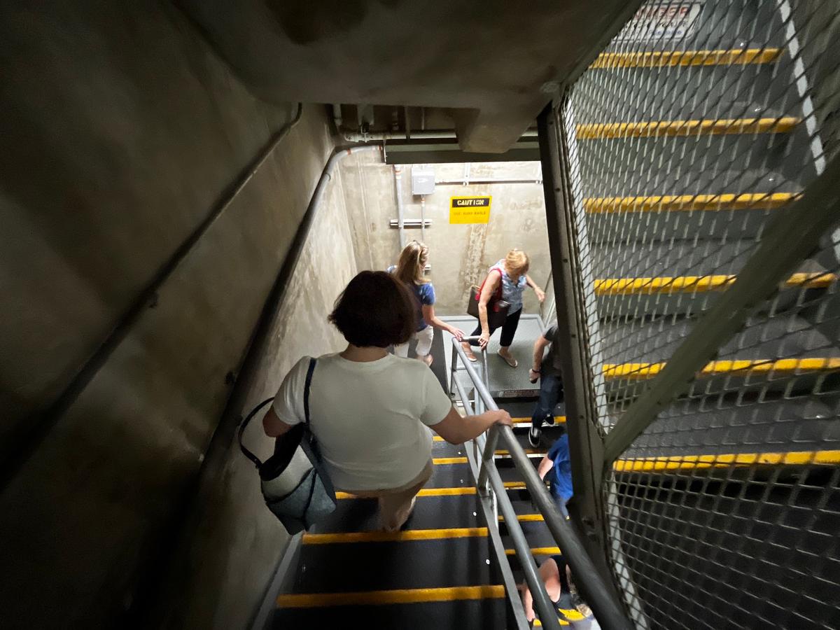 Visitors walk down a long flight of stairs to an underground former missile launch complex at the Titan Missile Museum in Green Valley, Ariz., on July 24, 2026. (Allan Stein/The Epoch Times)