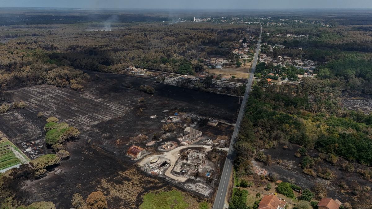 This aerial view shows damaged houses in a burnt area in the town of Le Porge, following a wildfire in the Gironde Department, south-western France, on July 27, 2026. (Ed Jones/AFP via Getty Images)