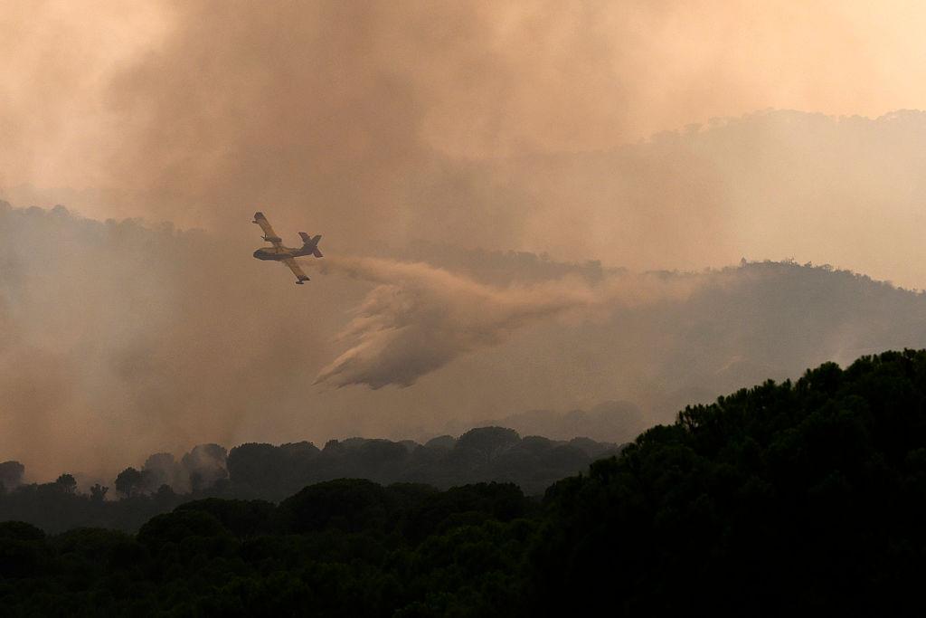 A firefighting airplane drops water on a wildfire near the village of Cebreros, Avila province, Spain, on July 27, 2026.  (Miguel Riopa/AFP via Getty Images)