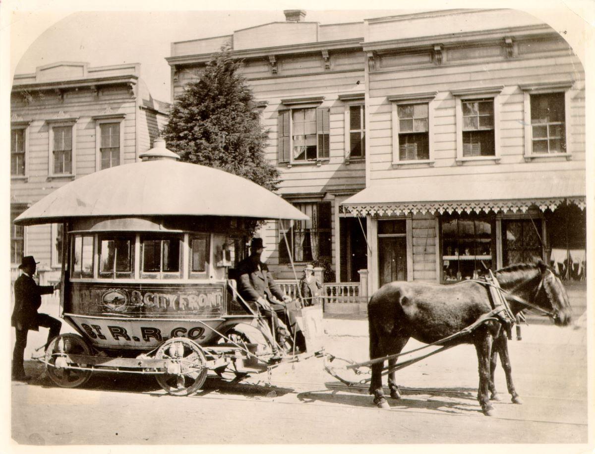Horse drawn "balloon car" belonging to the Sutter Street Railroad Company, a streetcar operator in San Francisco, circa 1871. San Francisco Public Library. (Public Domain)