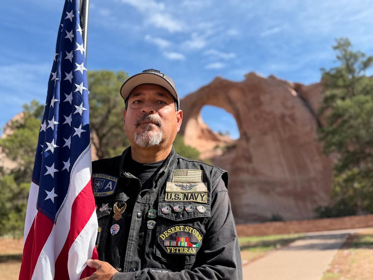 Navy veteran Mike Camarillo accepts the flag as the next bearer on its 14,000-mile journey through 50 states in Window Rock, Ariz., on July 28, 2026. (Allan Stein/The Epoch Times)