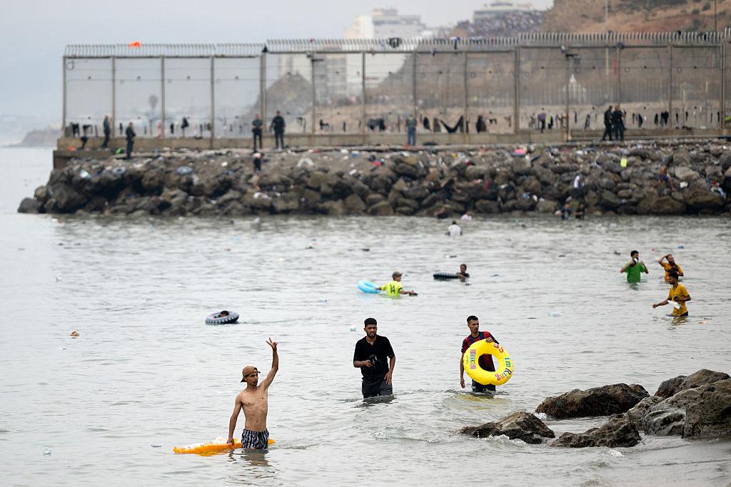 Migrants swim through the waters close to the border with Morocco to enter Spain's north African Ceuta exclave on July 31, 2026. (Jorge Guerrero/AFP via Getty Images)