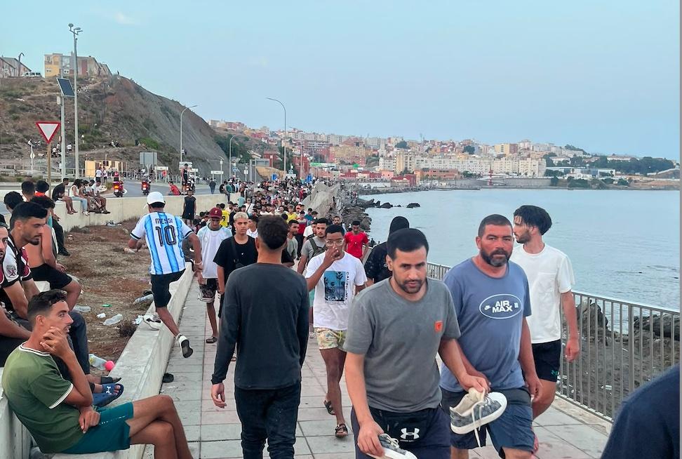 Moroccan immigrants walk and gather on the avenue Martinez Catena in Ceuta, Spain, on July 31, 2026. (Etienne Fauchaire/The Epoch Times)