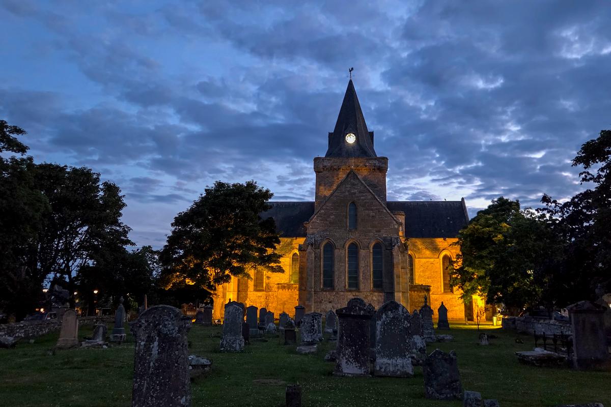The Dornoch Cathedral and cemetery have a moody ambiance at dusk in Dornoch, a town in the Highlands of Scotland, on July 3, 2026. (Patrick Connolly/Orlando Sentinel/TNS)