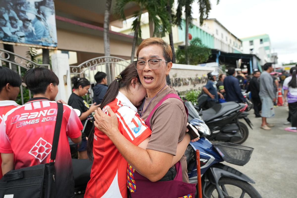A schoolgirl cries and is embraced by a relative outside a school where a shooting took place, in Nonthaburi province, Thailand, on Aug. 7, 2026. (Sakchai Lalit/AP)