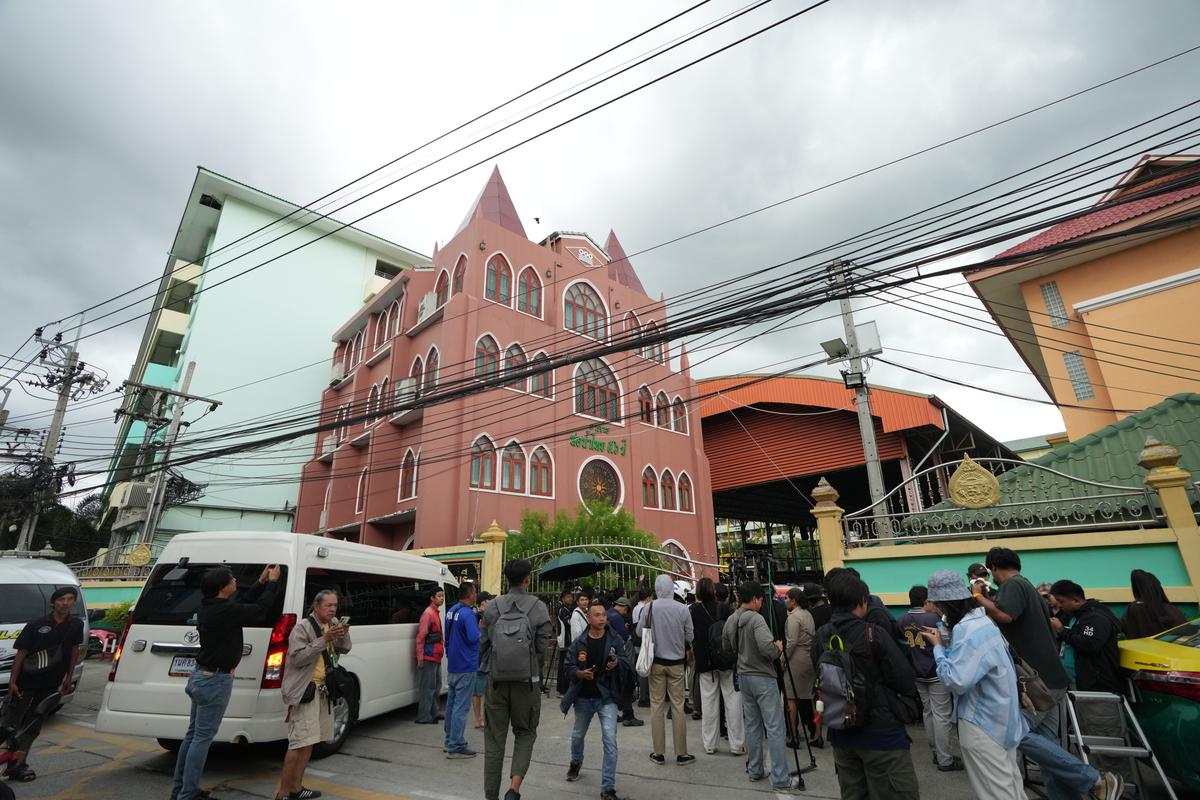 A crowd gathers outside a school in Nonthaburi province, Thailand, on Aug. 7, 2026. (Sakchai Lalit/AP)