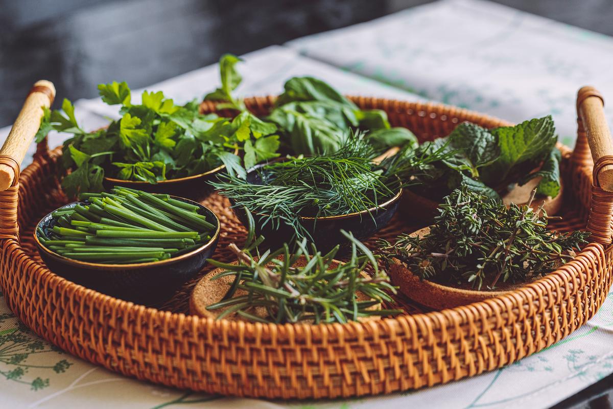 If planted in containers and brought indoors, herbs can continue gracing the table throughout the winter. (Eva-Katalin/Getty Images)