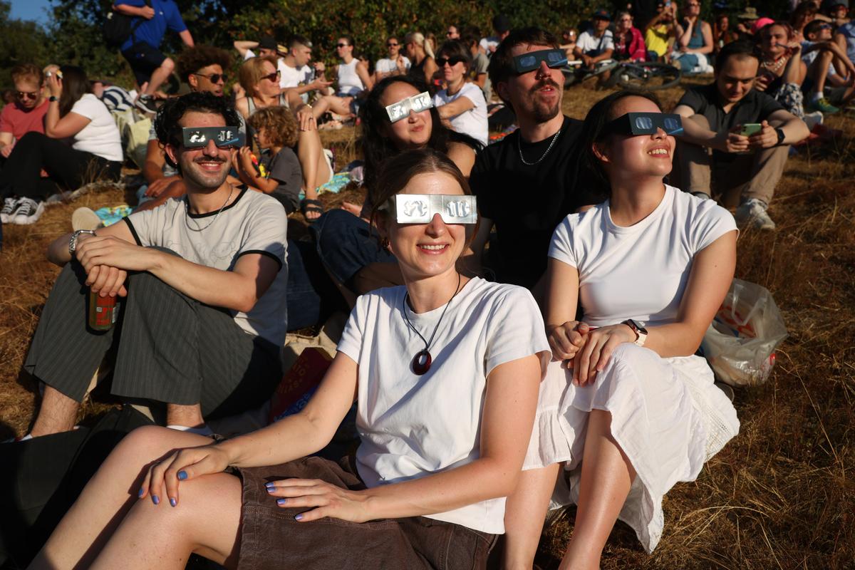 People gather to view the partial solar eclipse in Greenwich Park in London on Aug. 12, 2026. The partial solar eclipse is the most coverage during an eclipse viewed from the UK since 1999, with the moon covering 90-96 percent of the sun. (Dan Kitwood/Getty Images)