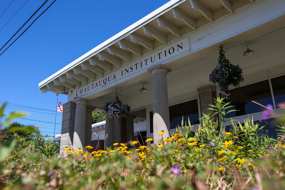 Flowers bloom outside the Chautauqua Institution welcome center in Chautauqua, N.Y., on Aug. 12, 2022. (AP Photo/Joshua Bessex)