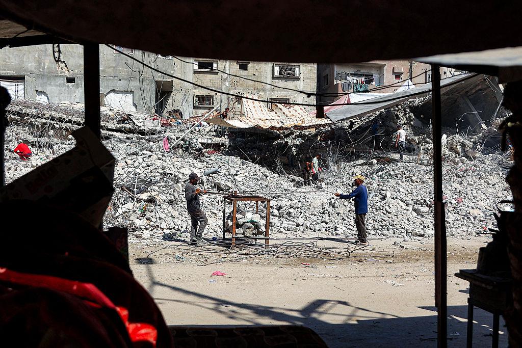 Salvage workers scrap steel rods from the rubble of a building that was destroyed during Israel's war against Hamas in Gaza, to use the recycled remains in the future, in Gaza City on Aug. 16, 2026. (Omar Al-Qattaa/AFP via Getty Images)