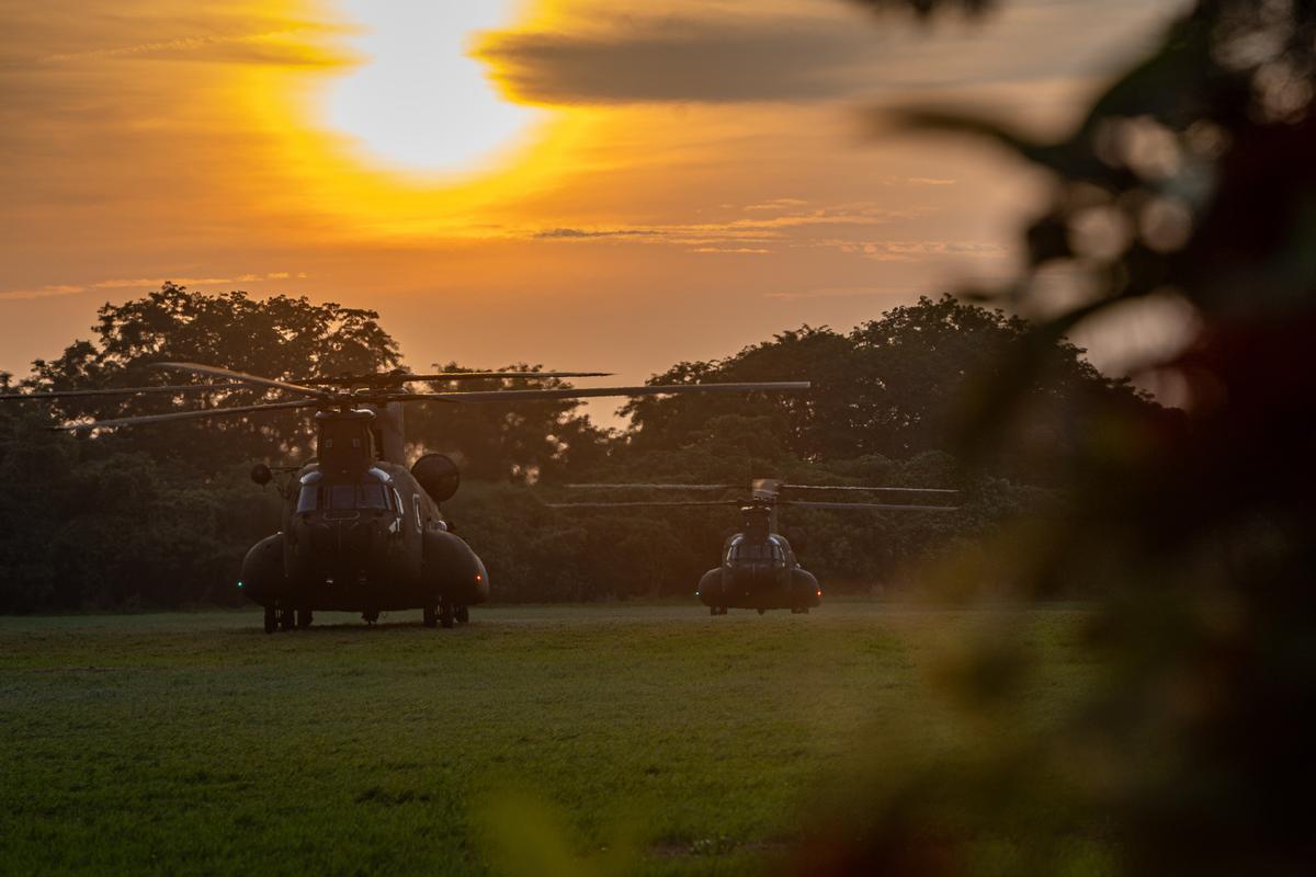 Taiwan Army CH-47SD Chinook transport helicopters sit on the grass field at sunset during a tactical exercise in Tainan, Taiwan, on Aug. 12, 2026 . (Cheng Chia Huang/Getty Images)