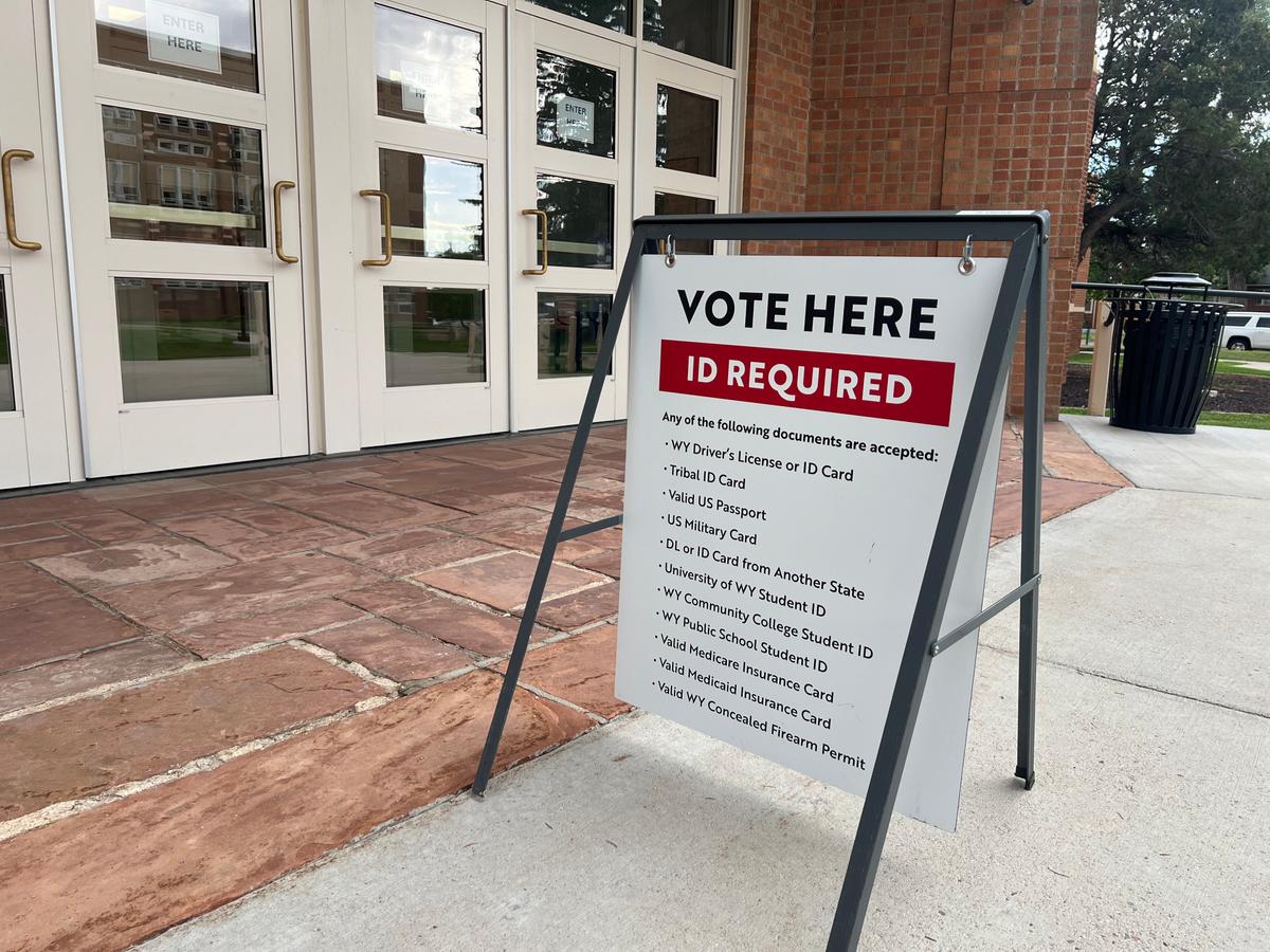 A sign displayed voter identification requirements for the primary election on Aug. 18 outside the Storey Gymnasium polling location in Cheyenne, Wyo. (Jacki Thrapp/The Epoch Times)