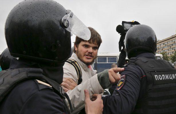 Police officers detain a protestor during an unsanctioned rally in the center of Moscow, Russia, on Aug. 3, 2019. (Pavel Golovkin/AP Photo)