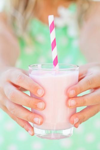 Post Workout Smoothie (<a href="http://www.shutterstock.com/pic-176268659/stock-photo-closeup-of-glass-of-smoothie-drink-with-straw-held-in-hands-by-young-girl.html?src=Eu9AiUX0QE-WrZXj3ULlvA-1-0&ws=1" target="_blank">Shutterstock</a>)