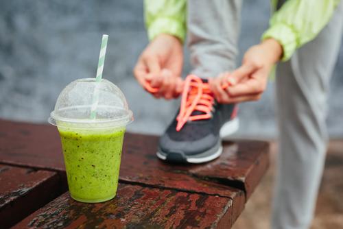 For those of us who feel we could be eating more raw foods, smoothies are a great place to start. (<a href="http://www.shutterstock.com/pic-188498762/stock-photo-green-detox-smoothie-cup-and-woman-lacing-running-shoes-before-workout-on-rainy-day-fitness-and.html?src=LioqU-syhzJEKB2zB_M2Gg-1-0&ws=1" target="_blank">Shutterstock</a>)
