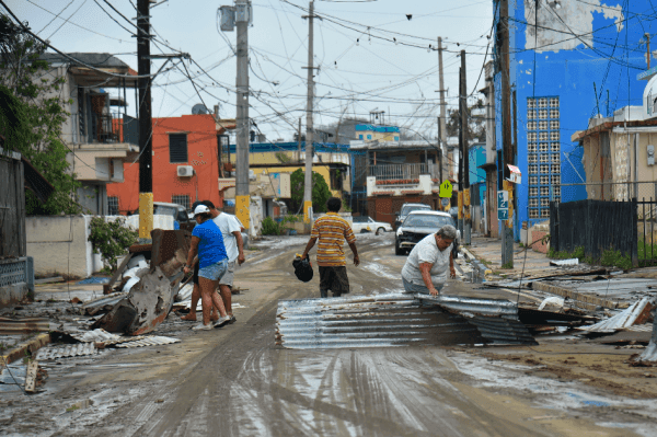 People work cleaning the streets after the passage of Hurricane Maria, in Toa Baja, Puerto Rico, on Sept. 22, 2017. (HECTOR RETAMAL/AFP/Getty Images)
