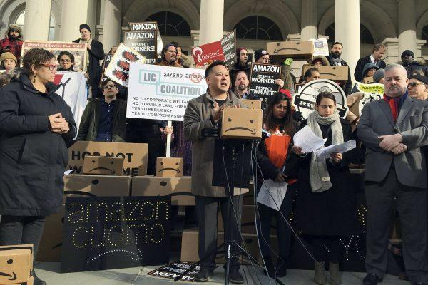 State Assemblyman Ron Kim, center, as he speaks at a rally opposing New York's deal with Amazon, on the steps of New York's City Hall, on Dec. 12, 2018. (Karen Matthews/AP Photo)