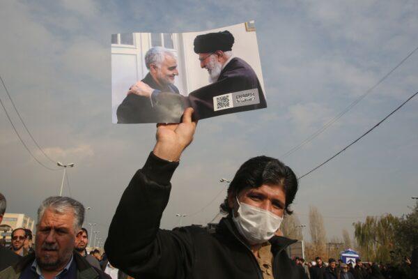 A man holds a picture of Iran's supreme leader Ayatollah Ali Khamenei with Iranian Revolutionary Guards Major General Qassem Soleimani (L) during a demonstration in Tehran on Jan. 3, 2020. (Atta Kenare/AFP via Getty Images)