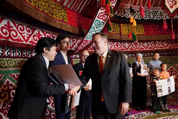 U.S. Secretary of State Mike Pompeo, center, meets with Kazakh citizens who said their family members are detained in Xinjiang, China. The meeting was held in a yurt at the U.S. Ambassador's residence in Nur-sultan, Kazakhstan, on Feb. 2, 2020. (Kevin Lamarque/Pool Photo via AP)