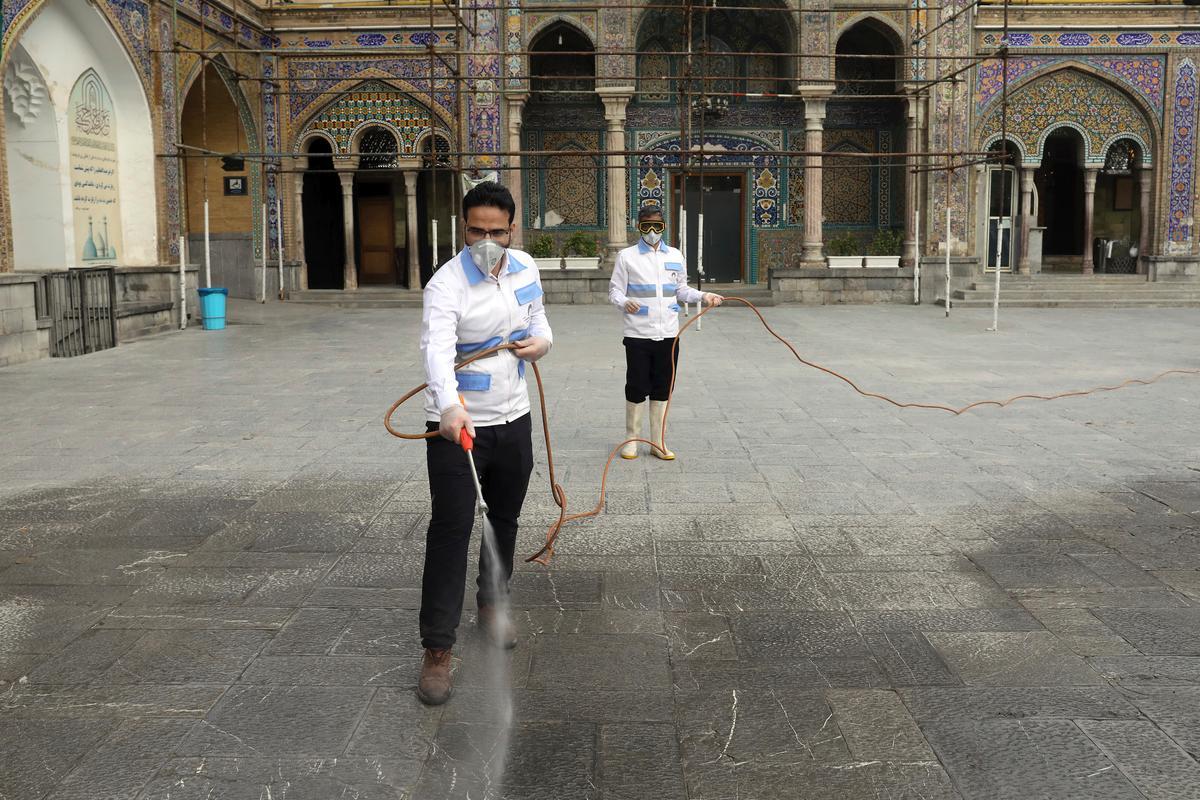 Workers disinfect the shrine of the Shiite Saint Imam Abdulazim to help prevent the spread of the new coronavirus in Shahr-e-Ray, south of Tehran, Iran, on March, 7, 2020. (Ebrahim Noroozi/AP Photo)