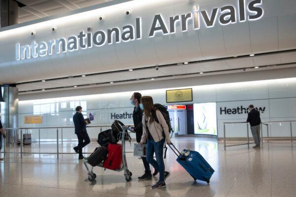 Travellers arrive at Heathrow Airport in London on July 8, 2020. (Matt Dunham/AP Photo)