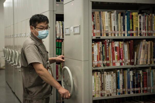 An employee checks the books at the Hubei Provincial Library in Wuhan, China on June 14, 2020. (Getty Images / Stringer)
