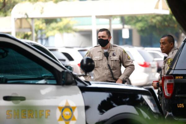 Los Angeles County Sheriffs Department deputies stand outside St. Francis Medical Center hospital following the ambush shooting of two deputies in Compton, in Lynwood, Calif., on Sept. 13, 2020. (Patrick T. Fallon/Reuter)
