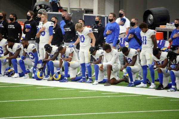 Jared Goff #16, Cooper Kupp #10, and Josh Reynolds #11 of the Los Angeles Rams stand as their teammates kneel during the national anthem before their game against the Dallas Cowboys at SoFi Stadium in Inglewood, California, on Sept. 13, 2020. (Katelyn Mulcahy/Getty Images)