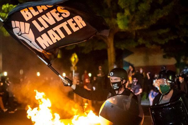 Protesters gather in front of a fire near the North police precinct in Portland, Ore. on Sept. 6, 2020. This was the 101st consecutive night of disturbances in the city. (Nathan Howard/Getty Images)