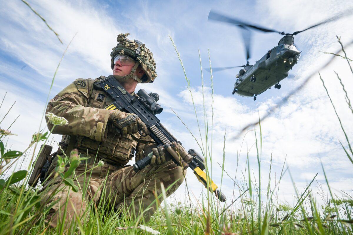 Private Patrick Rodgers of Britain’s Anglian Regiment, 2nd Battalion, maintains the perimeter as a Chinook helicopter carries out a medical evacuation during a military exercise on Salisbury Plains near Warminster, England, on July 23, 2020. (Leon Neal/Getty Images)