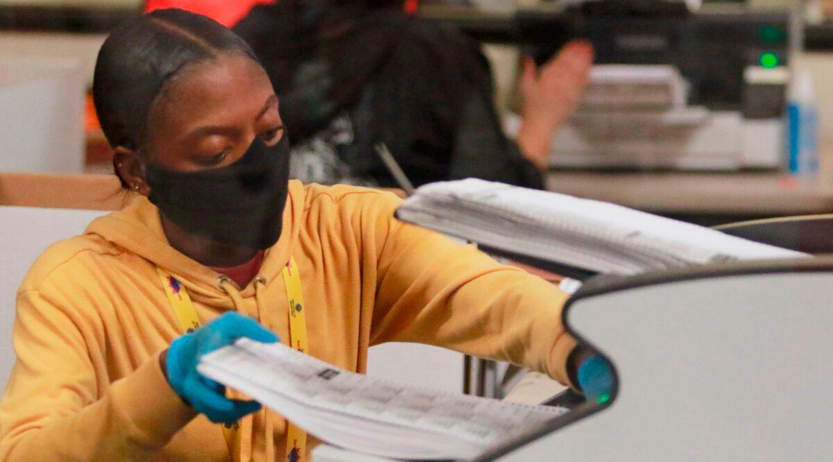 A worker handles official ballots at the Clark County Election Department in North Las Vegas, Nev., on Nov. 5, 2020,. (Ronda Churchill/AFP via Getty Images)