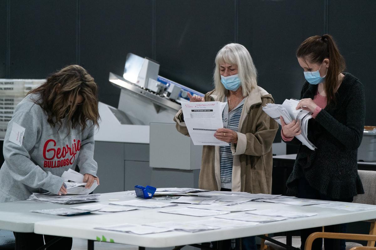 Election personnel sort absentee ballot applications for storage at the Gwinnett County Board of Voter Registrations and Elections offices in Lawrenceville, Ga., on Nov. 7, 2020. (Elijah Nouvelage/Getty Images)