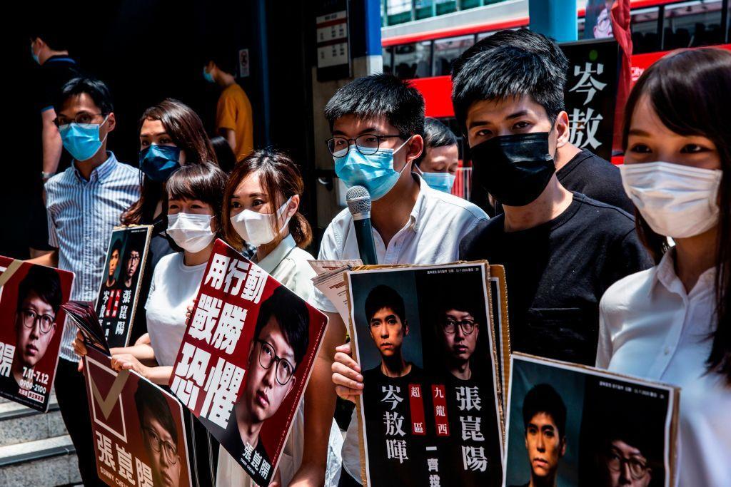 (L–R) Pro-democracy activists Eddie Chu, Gwyneth Ho, Leung Hoi-ching, Tiffany Yuen, Joshua Wong, Lester Shum, and Agnes Chow campaign during primary elections in Hong Kong on July 12, 2020. (Issac Lawrence/AFP via Getty Images)