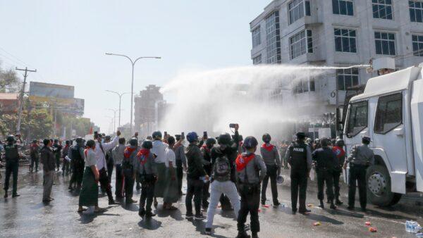 Police use water cannon to disperse demonstrators during a protest in Mandalay, Burma, on Feb. 9, 2021. (AP Photo)