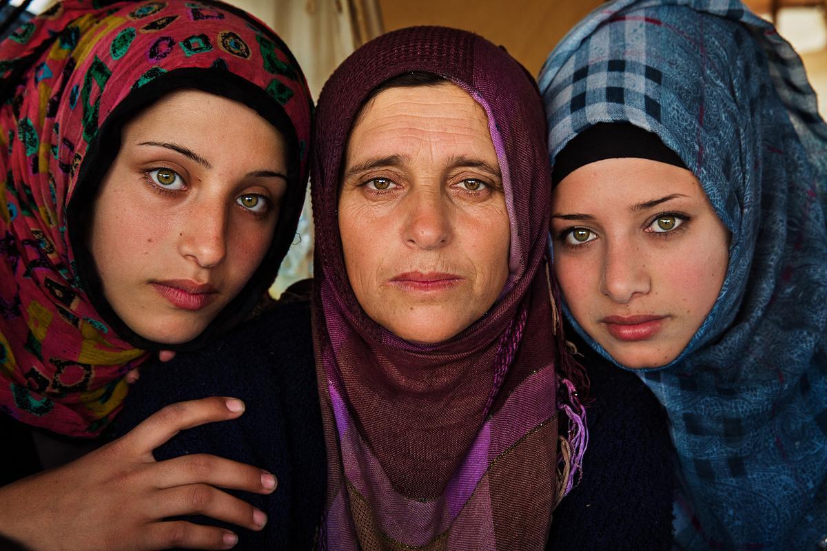 REFUGEE CAMP, GREECE, "This mother and her daughters fled the war in Syria" (Courtesy of <a href="https://theatlasofbeauty.com/">Mihaela Noroc</a>)