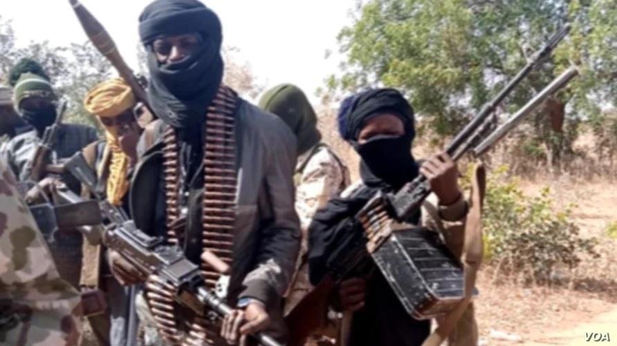 Members of a bandit gang pose with their weapons in northwest Zamfara state, Nigeria, on Feb. 22, 2021. (Voice of America)