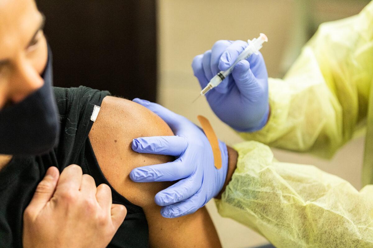 A healthcare worker prepares a COVID-19 vaccine at Lestonnac Health Clinic in Orange, Calif., on March 9, 2021. (John Fredricks/The Epoch Times)