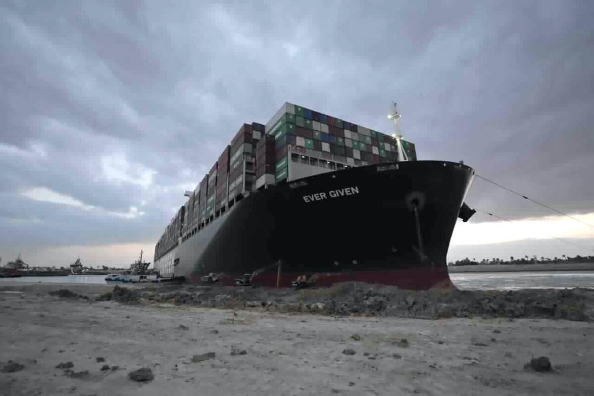Tug boats and diggers work to free the Panama-flagged, Japanese-owned Ever Given, which is lodged across the Suez Canal, Egypt, on March 28, 2021. (Suez Canal Authority via AP)