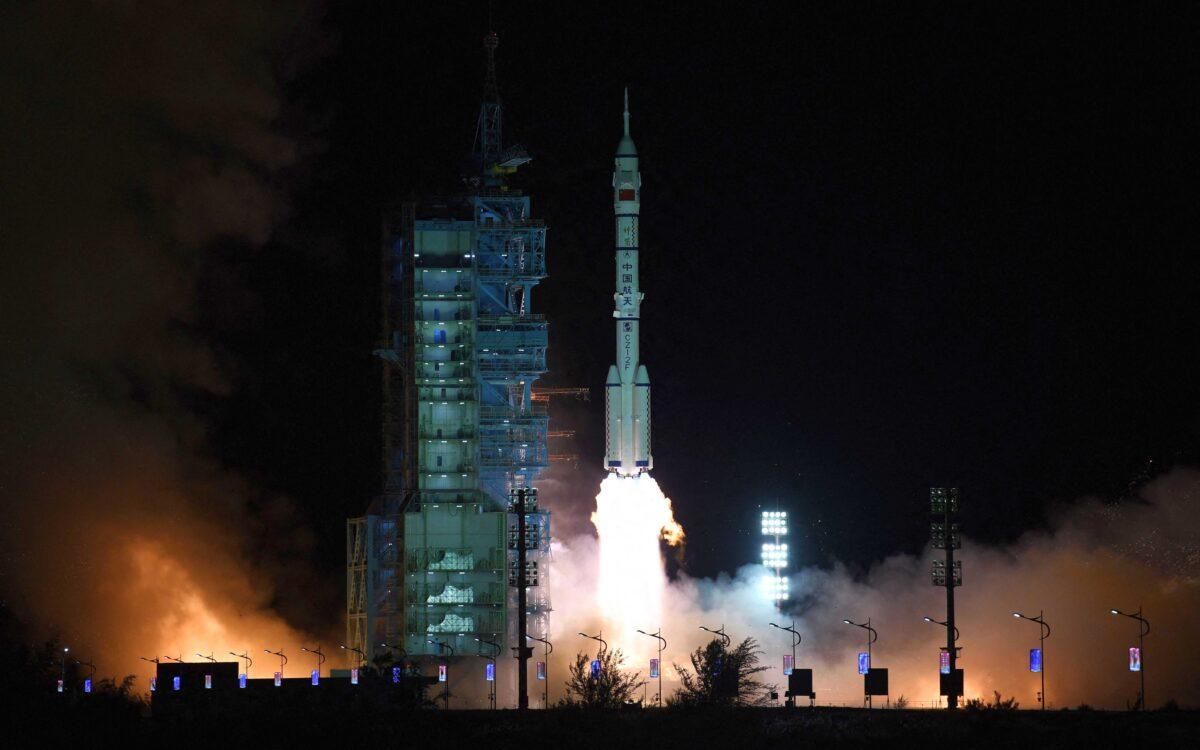 A Long March-2F carrier rocket, carrying the Shenzhou-13 spacecraft with the second crew of three astronauts to China's new space station, lifts off from the Jiuquan Satellite Launch Center in the Gobi desert in northwest China early on Oct. 16, 2021. (STR/AFP via Getty Images)