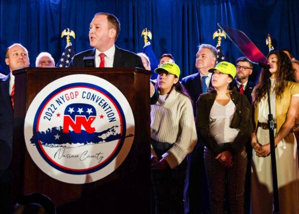 Rep. Lee Zeldin (R-N.Y.) accepts the nomination for governor at the New York State Republican Convention in Garden City, New York, on March 1, 2022, as his wife and daughters look on. (Dave Paone/The Epoch Times)