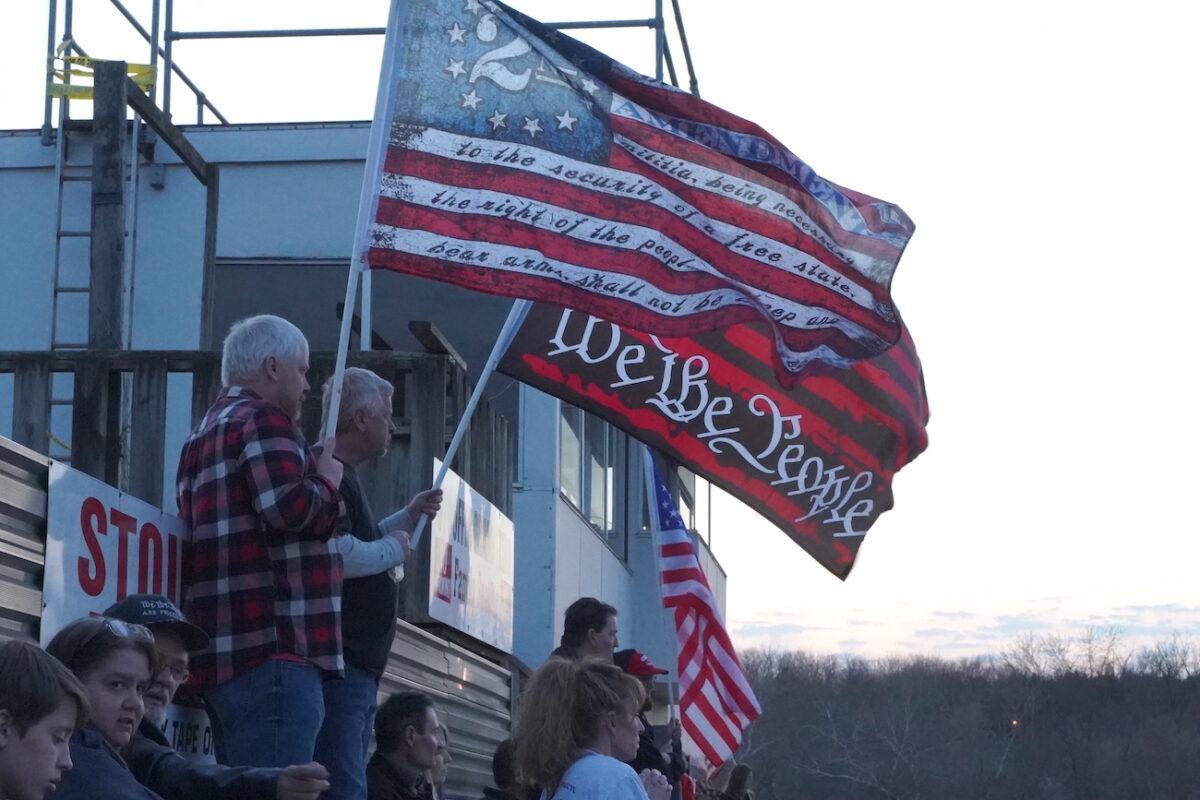 Men carrying "2nd Amendment" and "We The People" flags at a rally in Hagerstown Speedway, Hagerstown, Md., on March 5, 2022. (Enrico Trigoso/The Epoch Times)