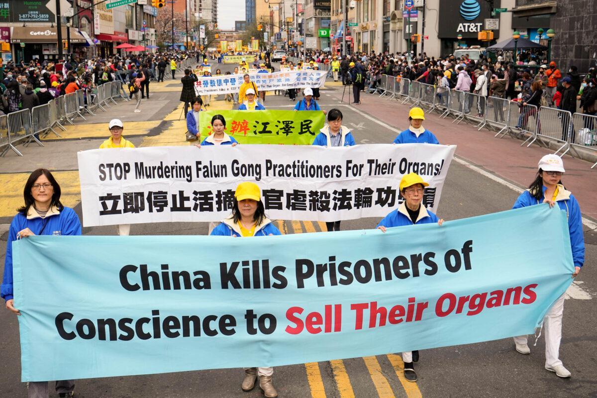 Falun Gong practitioners participate in a parade to commemorate the 23rd anniversary of the April 25th peaceful appeal of 10,000 Falun Gong practitioners in Beijing, in Flushing, N.Y., on April 23, 2022. (Larry Dye/The Epoch Times)