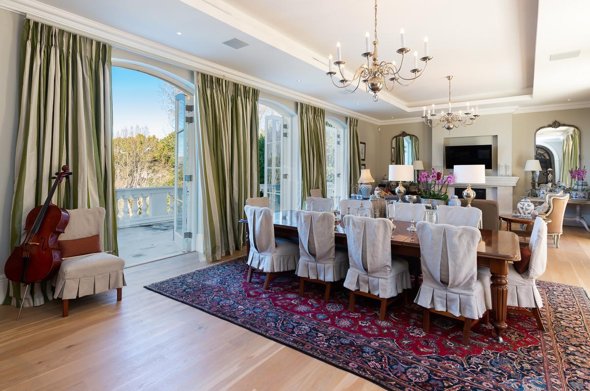 One of several formal dining/entertaining areas with terrace access. Outside, the owners and their guests have a remarkable view of the valley and the sea in the distance. (Greef Christie’s International Real Estate)