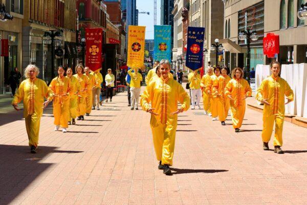 Falun Gong adherents march in a parade celebrating the 30th anniversary of the introduction of the spiritual practice, in Ottawa on May 10, 2022. (Jonathan Ren/The Epoch Times)